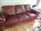 Maroon leather sofa.