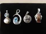 Four sterling pendants