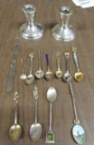 Weighted sterling candlesticks and collector spoons.