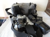 Canon AE-1 camera with accessories.
