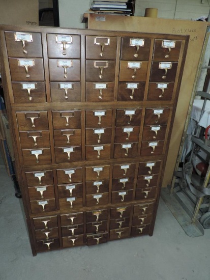 Sixty drawer hardware cabinet with brass hardware.