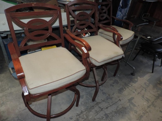 Three metal patio bar stools.