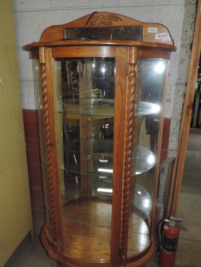 Oak china cabinet with glass shelves.