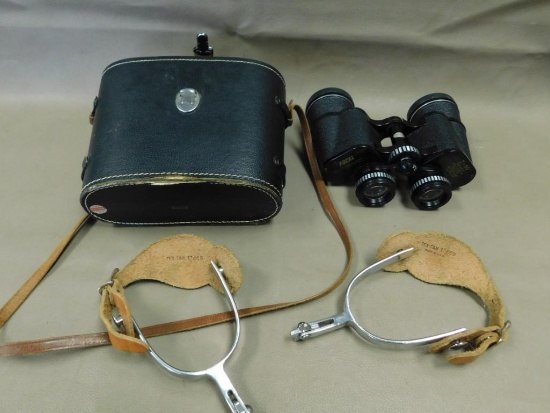 Binoculars and western spurs