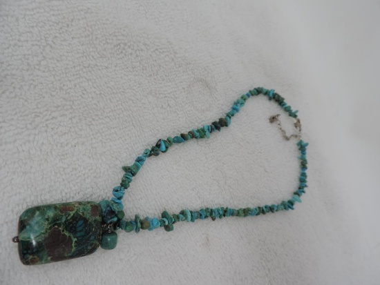 Polished stone necklace with sterling clasp.