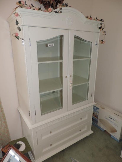 One piece white glass doored cabinet.