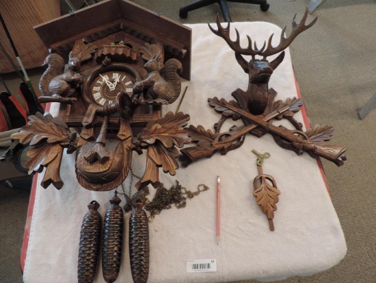 Ornate carved German wood coo coo clock.