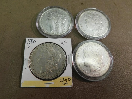 Four 1880 Morgan silver dollar coins