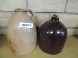 Two antique whiskey jugs.