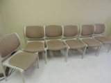 Six upholstered stacking chairs.