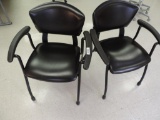 Two black faux leather fixture furniture chairs in excellent condition.