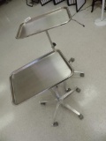 Two stainless steel trays with rolling stands.