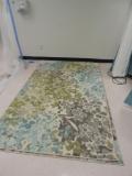 Three floral rugs.