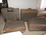 Four vintage suitcases.