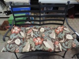 Black metal patio loveseat with cushion.