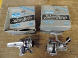 Two Daiwa 1000C spinning reels with boxes.