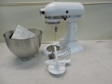 White kitchen aide classic mixer with bowl-attachments.