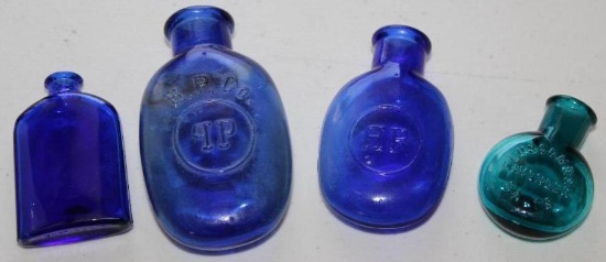 Four Small Blue Glass Bottles