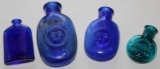 Four Small Blue Glass Bottles