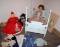 Four Antique Dolls with Wood Bed and Extra Clothes