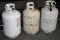 Three Empty Forklift Style Propane Canisters