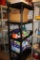 Black Plastic Storage Rack with Contents Like Food Storage Bags, TV Trays, and More