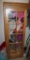 Wood Door Cabinet Filled with Mixed Sweaters, Scarves, Shirts, and More
