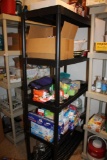 Black Plastic Storage Rack with Contents Like Food Storage Bags, TV Trays, and More