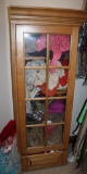Wood Door Cabinet Filled with Mixed Sweaters, Scarves, Shirts, and More