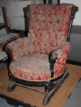 Antique Wood with Red and Gold Upholstery Spring Rocker with Scrollwork Wood Detail