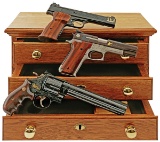 Wonderful Cased Three-Gun Set of Smith & Wesson Factory Engraved and Gold Inlaid Handguns Presented