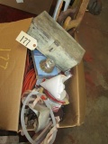 box of items including drop cords, saws