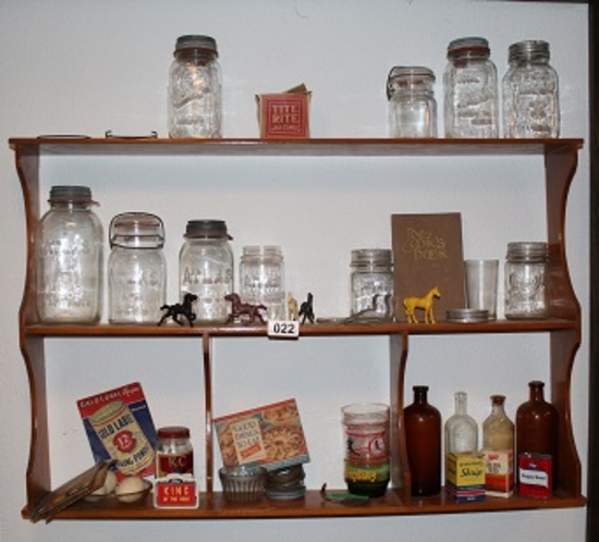 shelf of collectibles including Mason jars