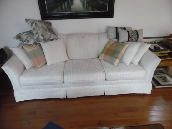 couch and love seat with throw pillows