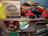 Two shelves of trimmers and yard chemicals